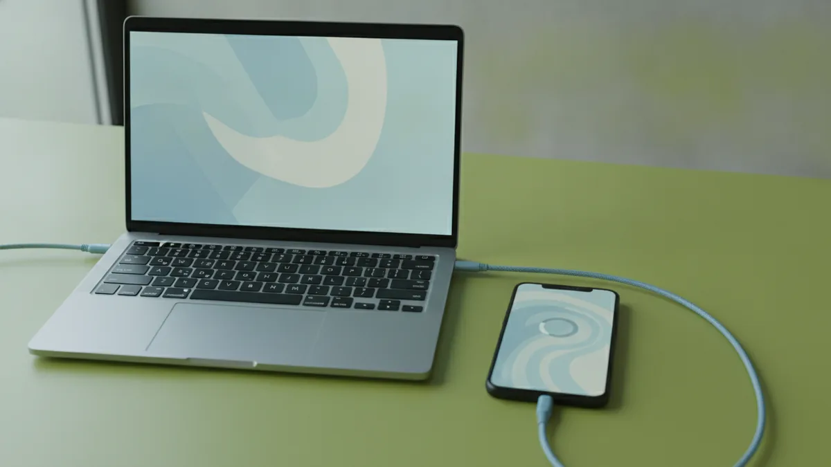 Identify the likely cause Connected phone and laptop setup to troubleshoot a stuck Apple logo issue