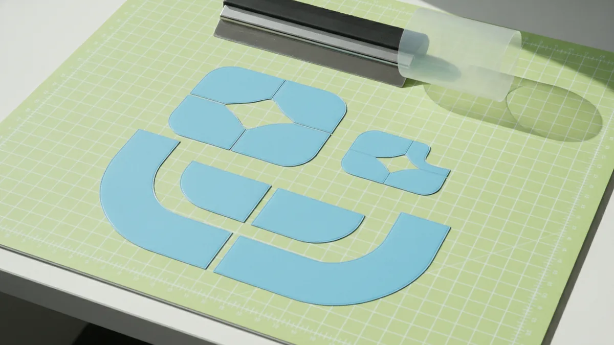 Clean weeding and alignment Weeding and aligning layered vinyl logo parts for crisp results.