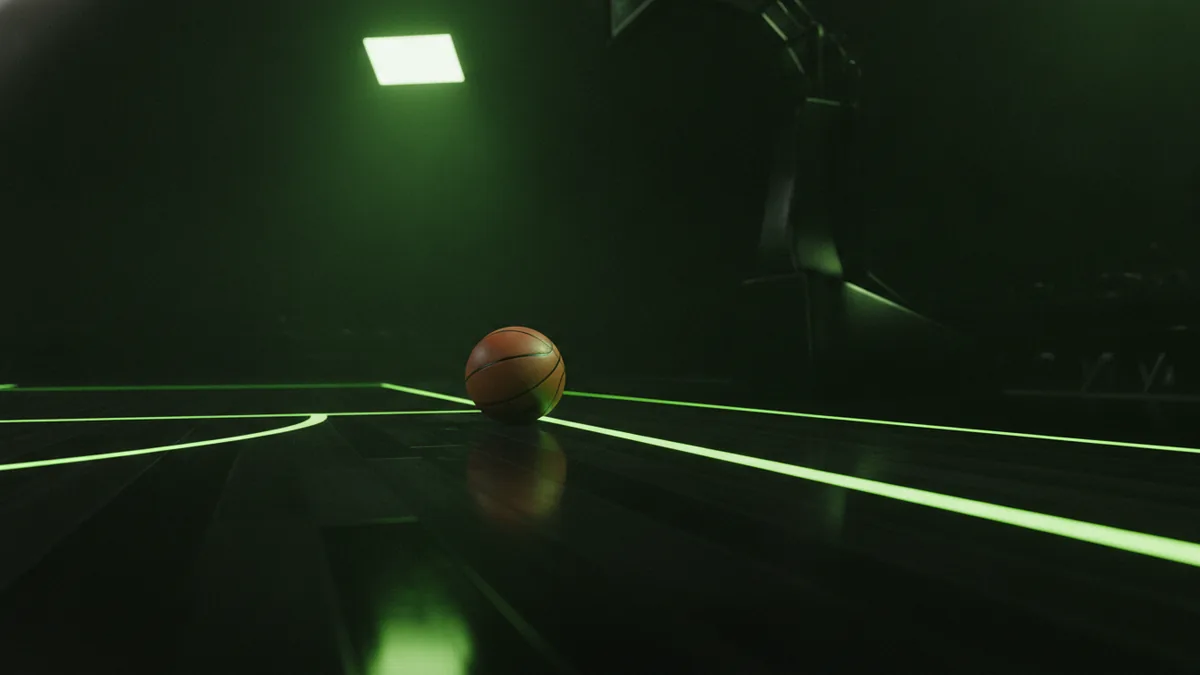 Basketball on the court edge under arena lights